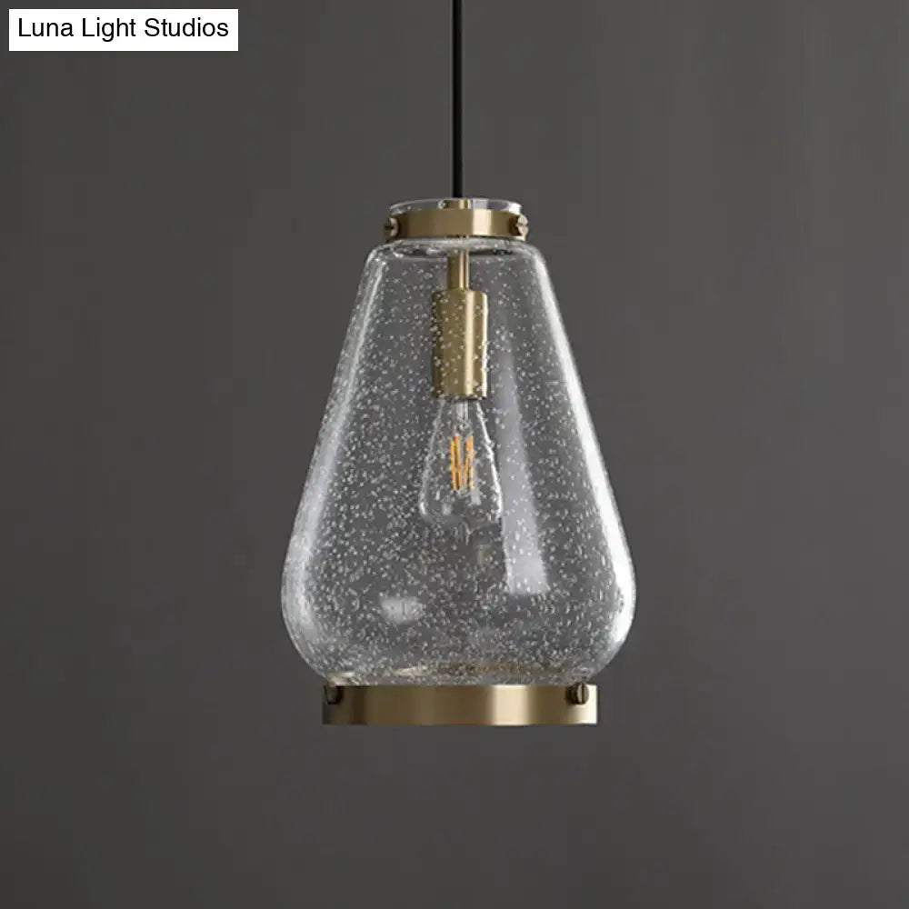 DecorBites™ seeded glass pendant light with speckled texture, brass rim, and exposed filament bulb for bedrooms