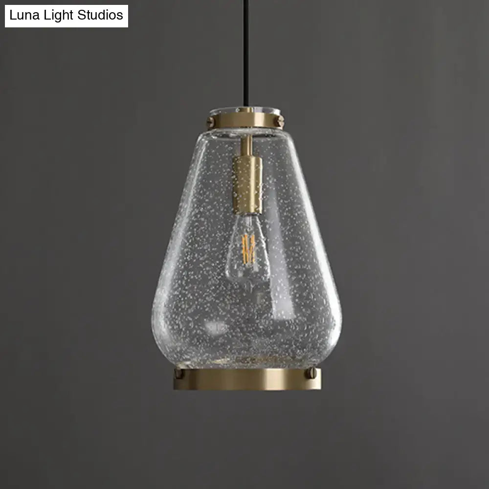DecorBites™ seeded glass pendant light with speckled texture and brass rim perfect for bedrooms
