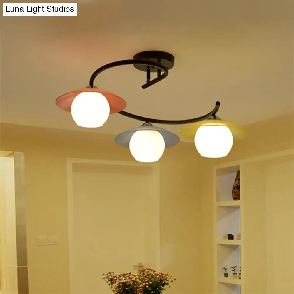 Decorbites semi flush light with black spiral metal arms and coral pink gray yellow glass shades three heads