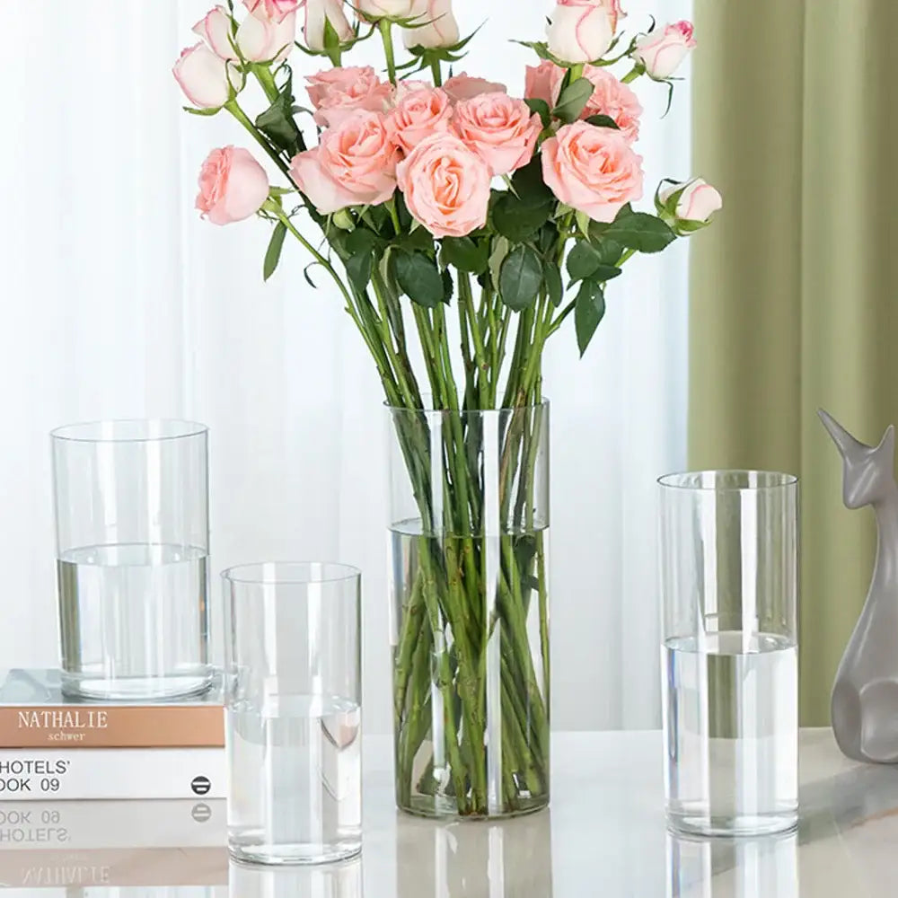 Tall clear acrylic cylinder vase holding pink roses featuring a shatterproof clear acrylic design by DecorBites™