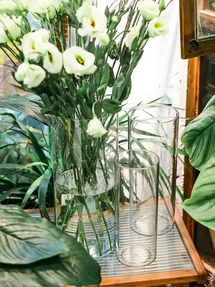 DecorBites™ shatterproof clear acrylic cylinder vase holding white lisianthus bouquet in tall clear acrylic design