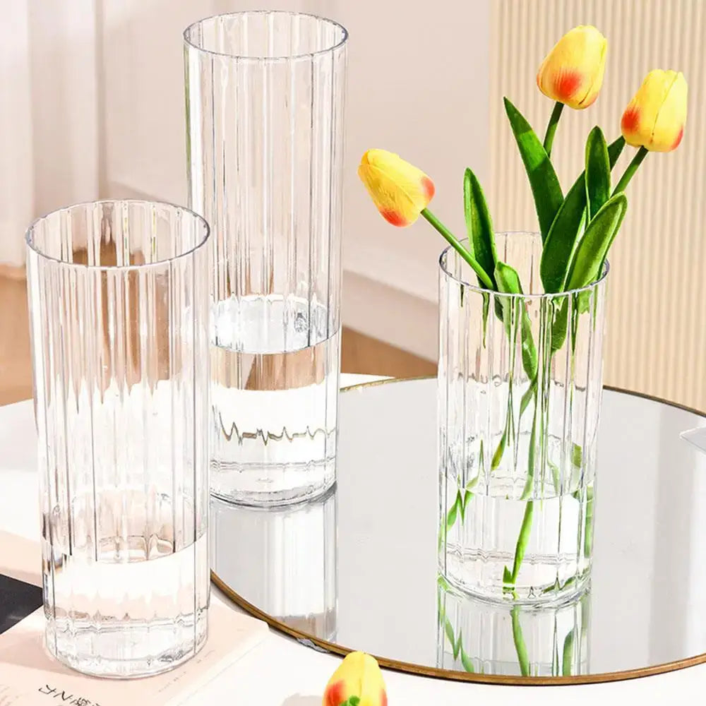Clear acrylic flower vases with vertical ribbed texture including one shatterproof clear acrylic flower vase holding yellow tulips