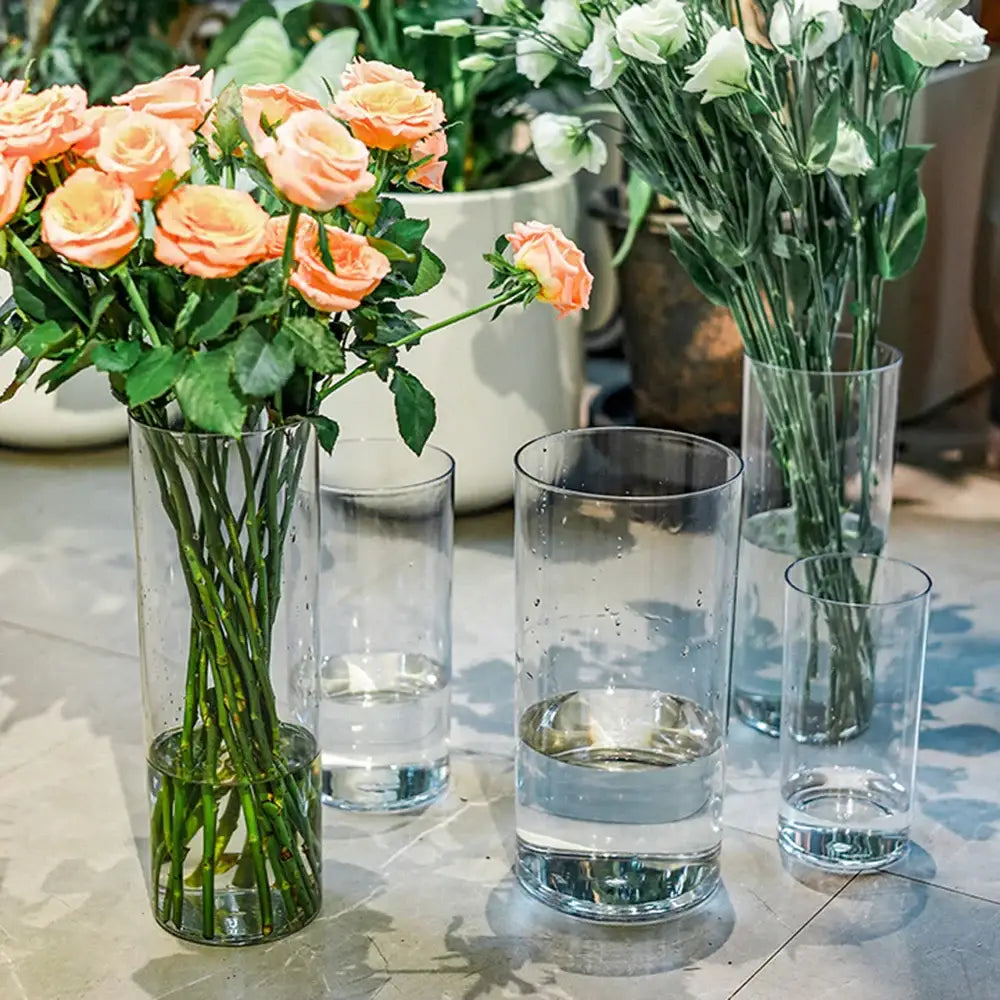 Clear cylindrical decorbites™ shatterproof tall transparent acrylic flower vases holding peach roses and water