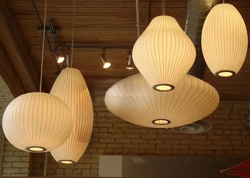Cream-colored ribbed silk led pendant lamp with warm glowing lights modern designer lighting by DecorBites