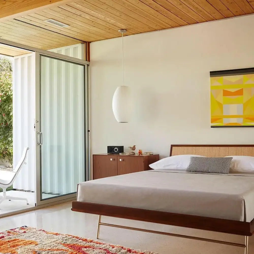 Mid-century modern bed with dark wood frame and woven rattan headboard beneath decorbites™ silk led pendant lamp