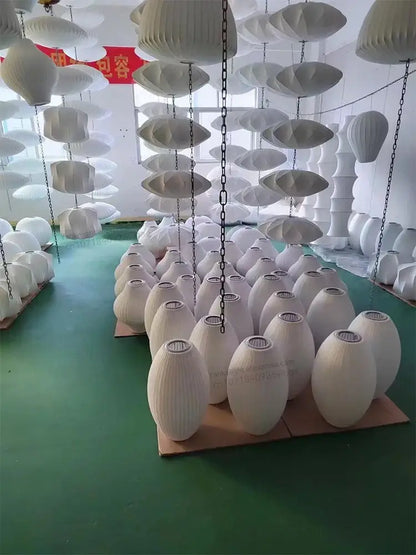 Decorbites™ silk led pendant lamp featuring white ribbed paper egg-shaped shades hanging in an industrial setting