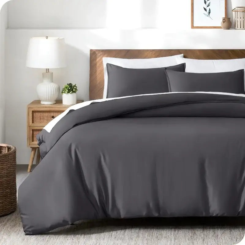 DecorBites silky cooling duvet cover set in dark gray with white piping and a smooth satin-like finish includes pillowcases