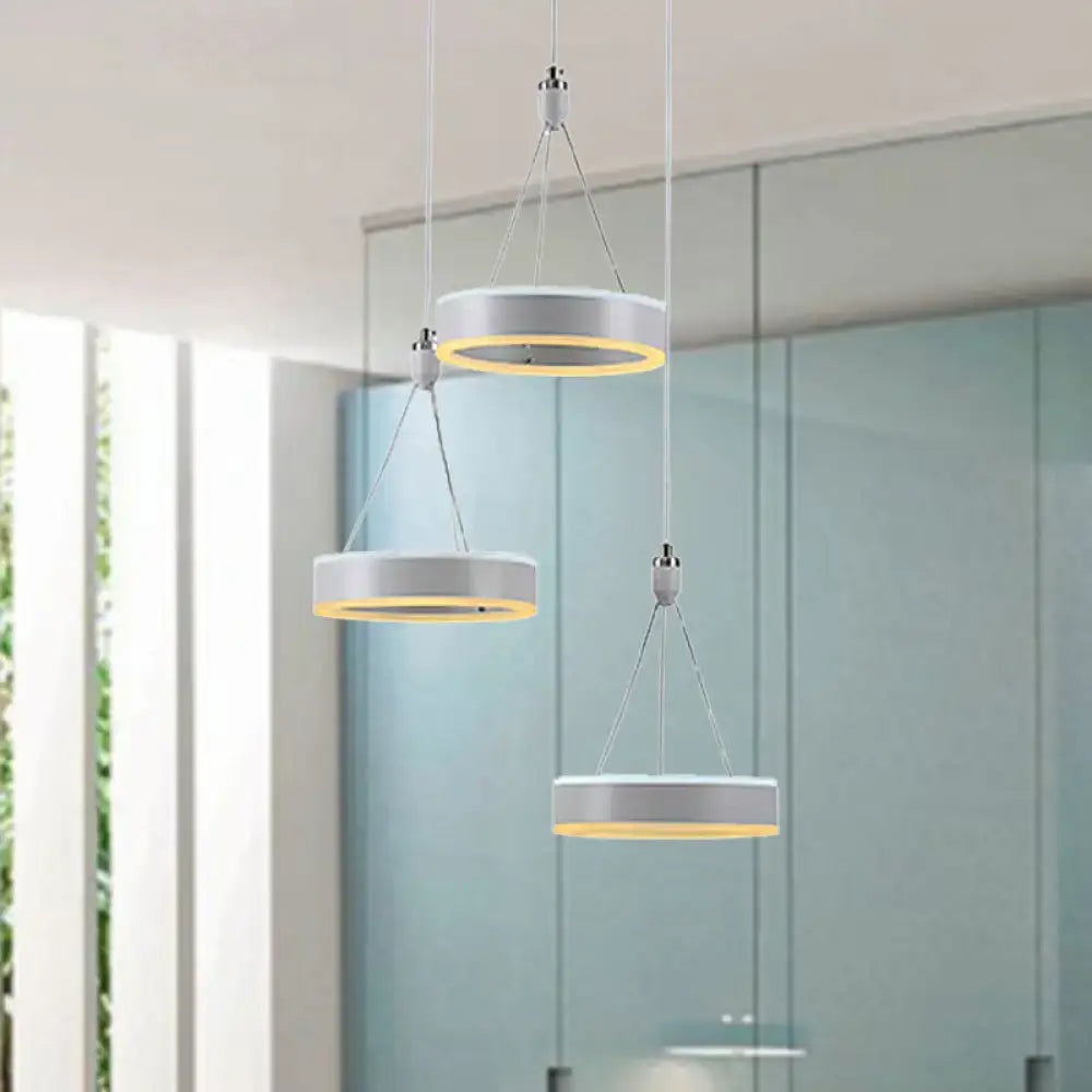 Modern white and silver cluster ceiling light with warm yellow led rings ideal for dining room illumination