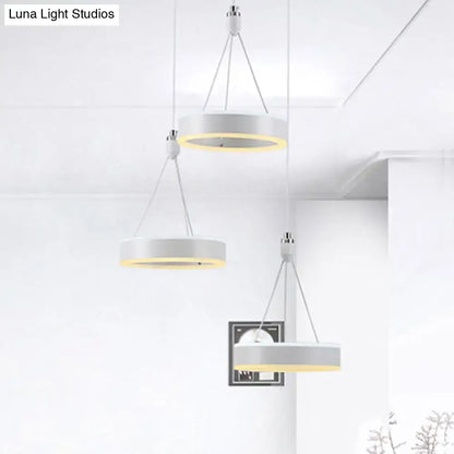Modern white and silver cluster ceiling light with warm yellow glow and LED rings for dining room illumination