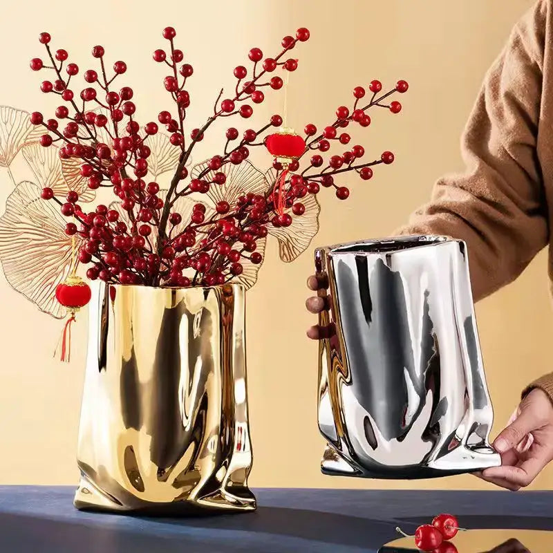 Shiny gold and silver metallic silver ruffled flower vase with a sculpted bag-like ceramic design by DecorBites