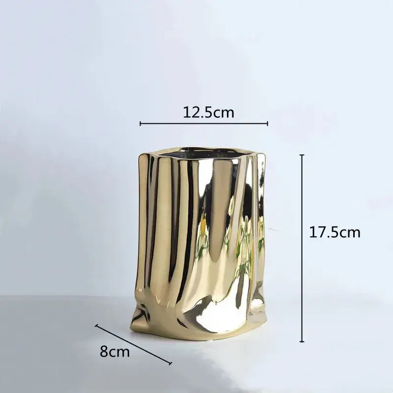 A sleek gold ceramic flower vase with textured ribbed surface and slightly irregular edges from decorbites silver ruffled collection