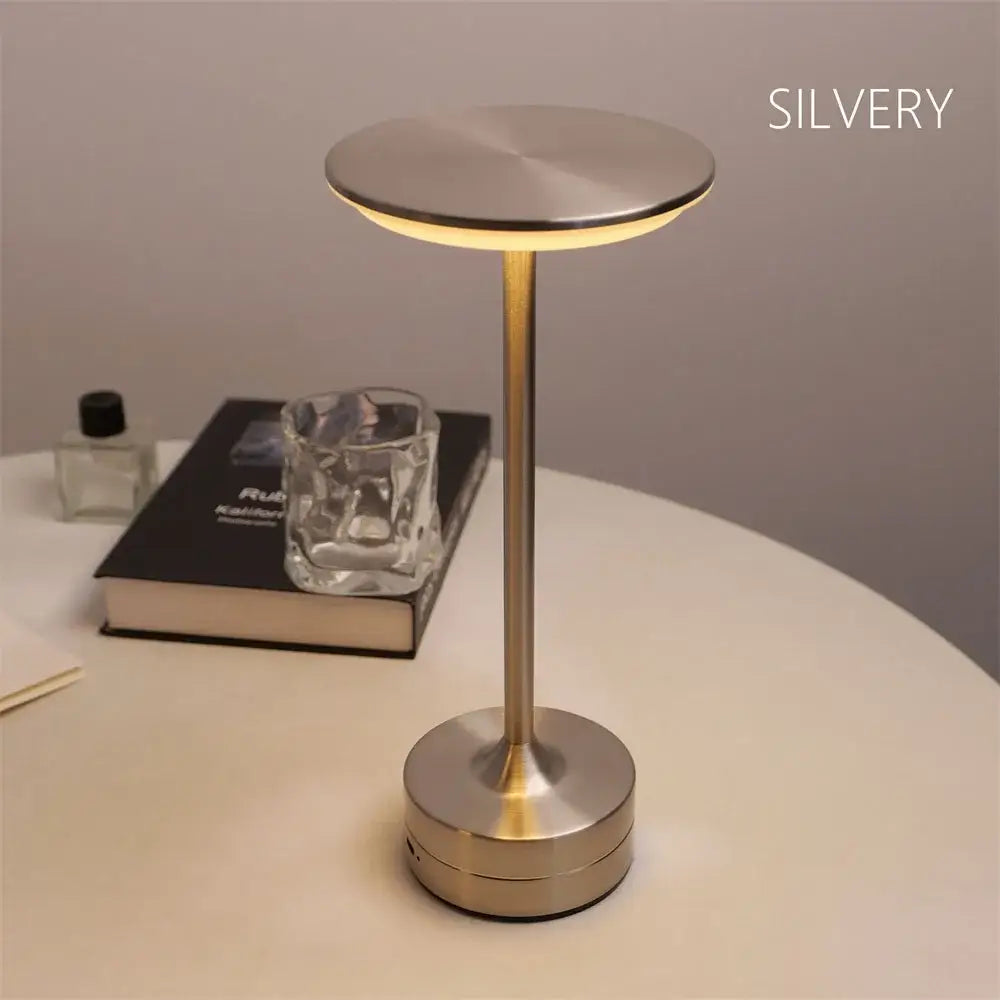 Silver metallic simple charging led desk lamp with minimalist design and circular base for office or restaurant use