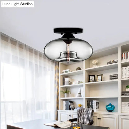 DecorBites™ simple style black flush mount with a glass oval flush smoky shade and exposed filament bulb for hallways