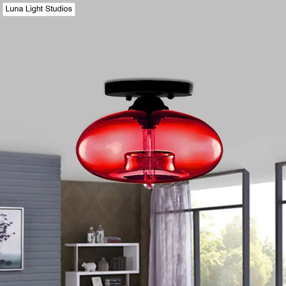 Vibrant red glass oval flush pendant light with sleek black metal ceiling mount from DecorBites flush mount collection