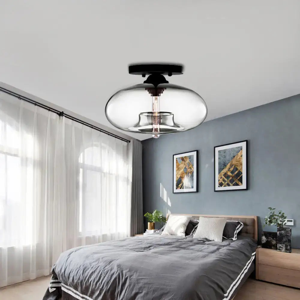 Modern black and clear glass oval flush mount light fixture with sleek rounded design for hallway lighting