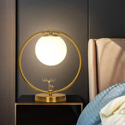 Gold-toned circular table lamp with ivory glass ball shade and delicate deer base for 220v-240v 110v-120v use