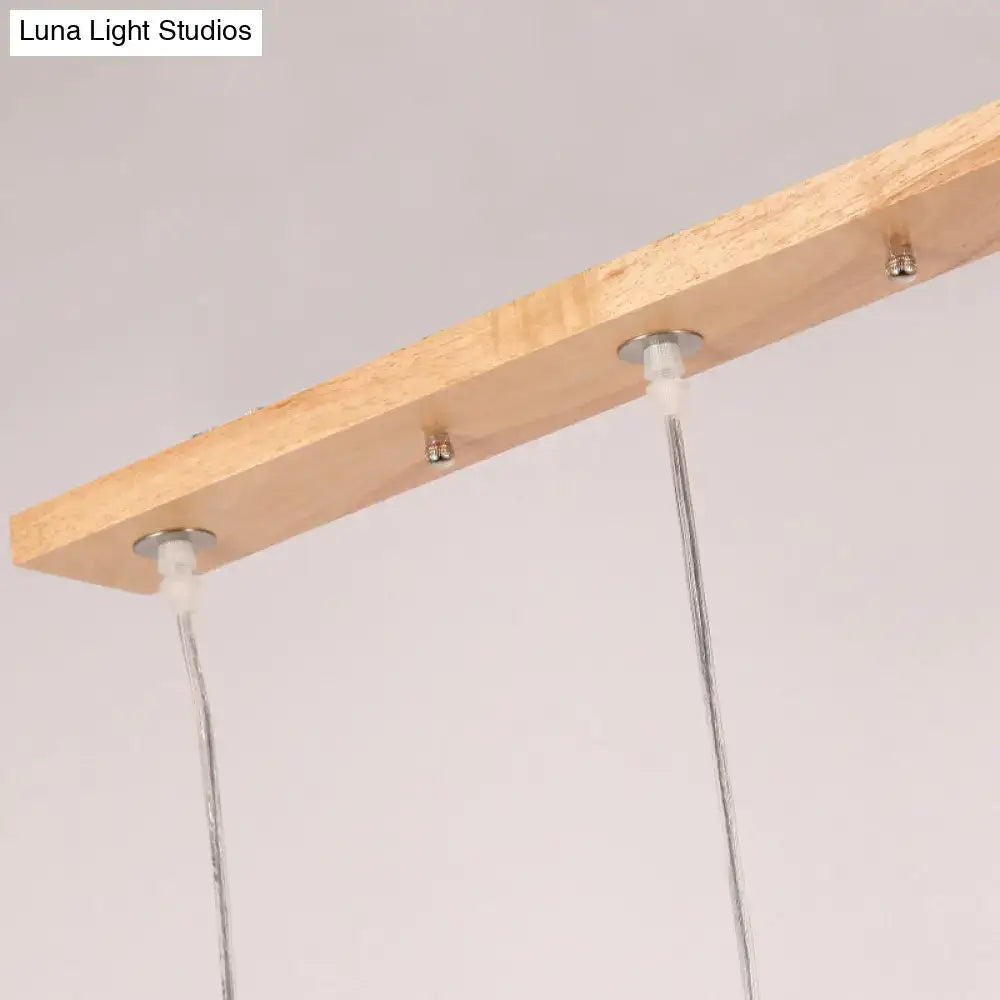Lightweight wooden rectangular island pendant light with three opaline glass shades and adjustable chain cord length