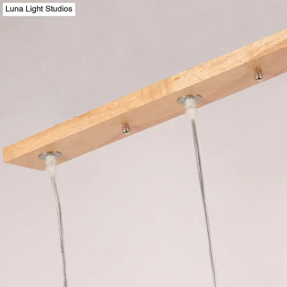 Lightweight wooden rectangular island pendant light with three opaline glass shades and adjustable chain cord length