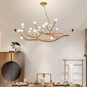 Golden iron tree branch chandelier with multiple spherical bulbs from decorbites simulation bubble design