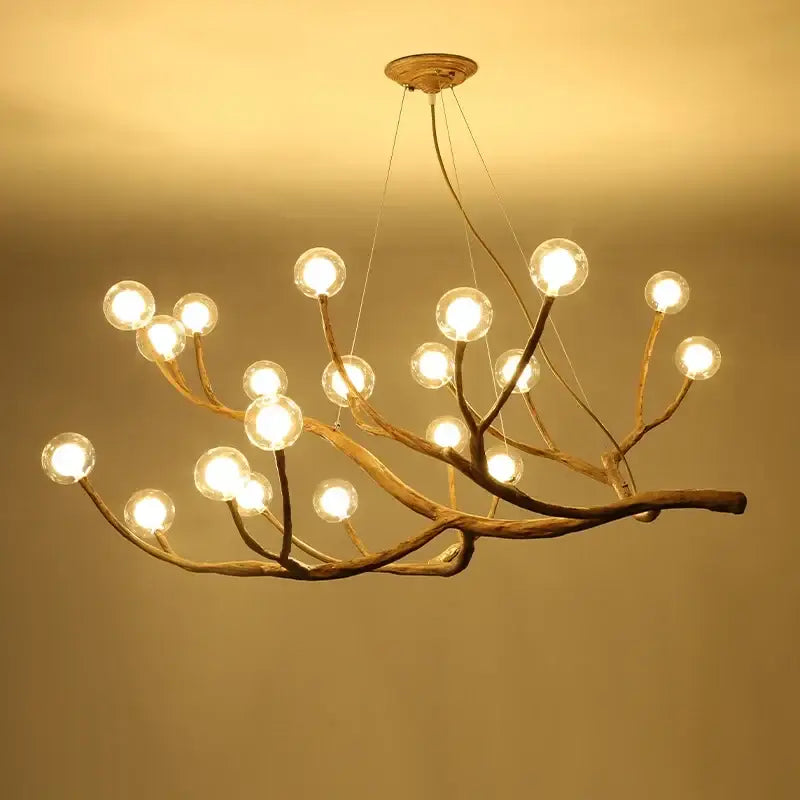 Decorbites simulation iron tree branch bubble chandelier featuring a rustic iron tree branch design with glowing bulbs