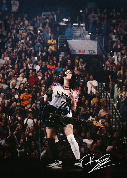 A signed canvas art print of singer b-billies performing in a white and blue 76ers jersey with a black electric guitar
