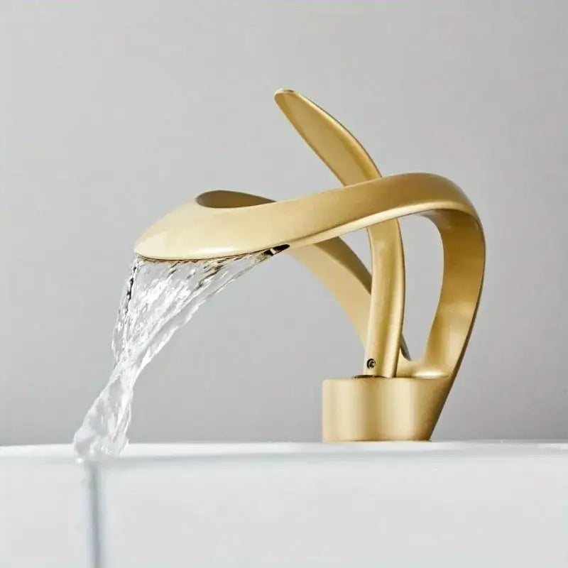 Gold-colored single handle bathroom sink faucet with sleek curved waterfall design for modern bathroom sink use