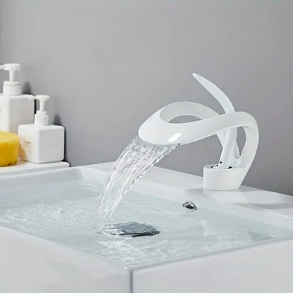 White ceramic single handle waterfall bathroom sink faucet with sleek modern design by DecorBites