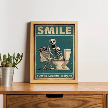 Framed teal canvas wall art by decorbites featuring a skeleton man squatting on a toilet reading a newspaper with text