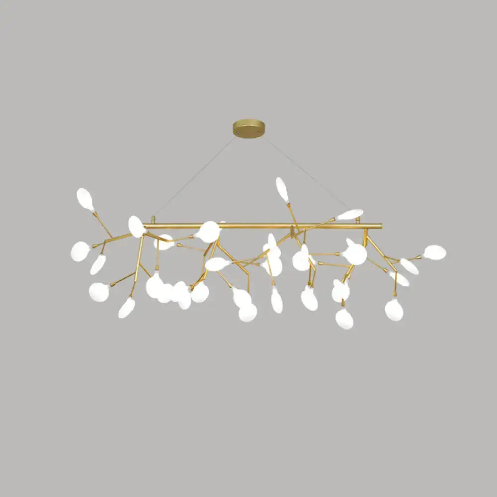 Gold-toned cast iron dining room branch-style chandelier with white opal glass leaf-shaped shades by DecorBites