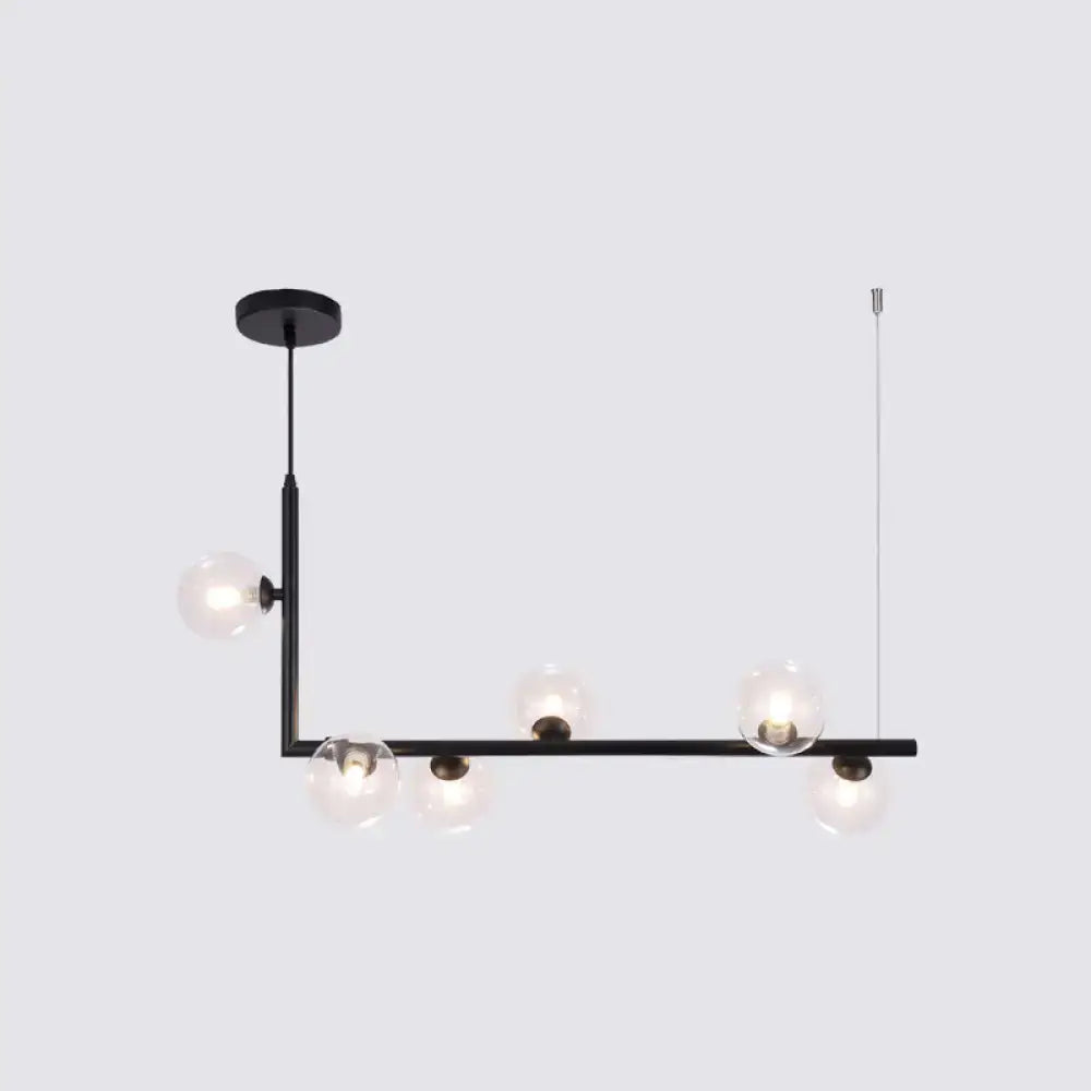 Modern black metal pendant light with five clear glass globes for dining room hanging island design by DecorBites