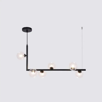Modern black metal pendant light with five clear glass globes for dining room hanging island design by DecorBites