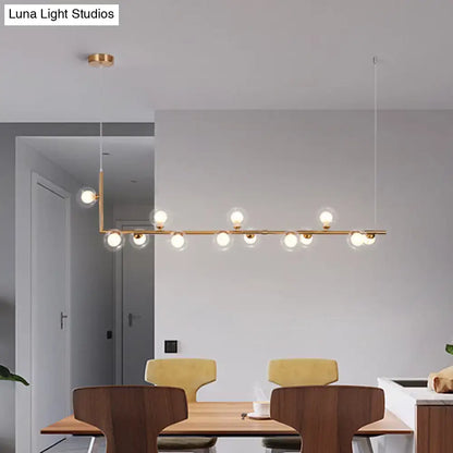 Modern gold-toned linear pendant light with multiple spherical glass bulbs for dining room hanging island decor