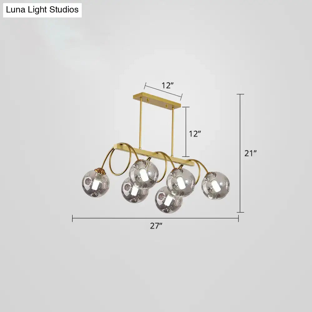 DecorBites sleek gold spiral island light with five glass globe bulbs and curved metal arms in gold finish