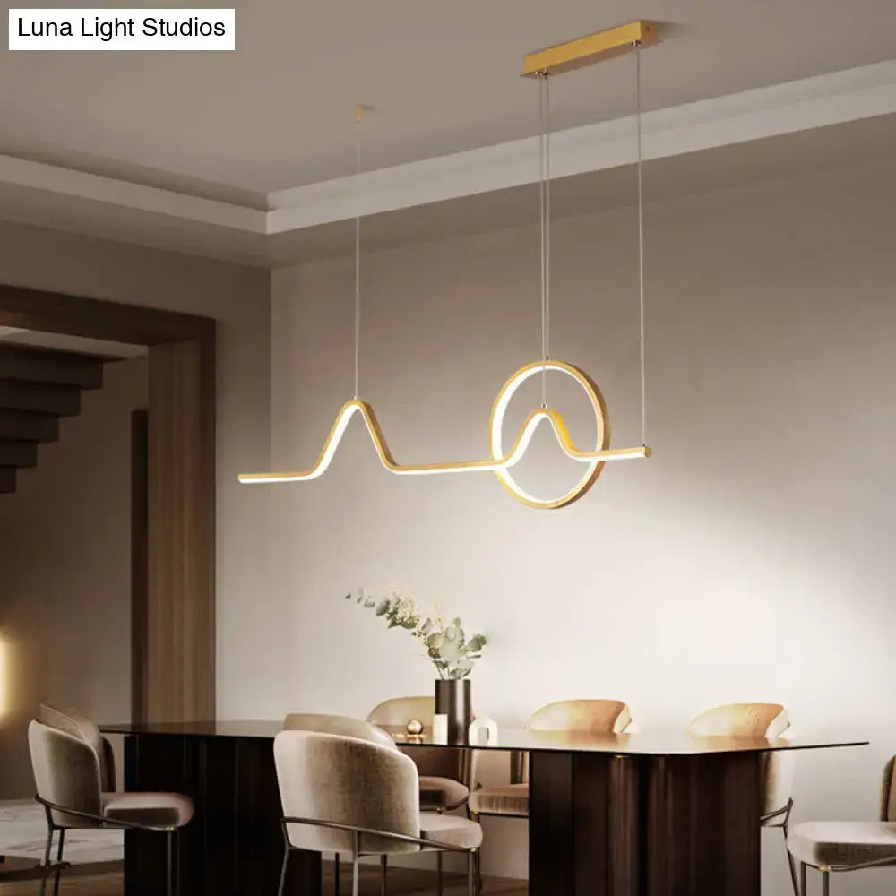 Modern gold-toned DecorBites™ island light fixture with sleek abstract wave and circular design in metallic suspension lighting