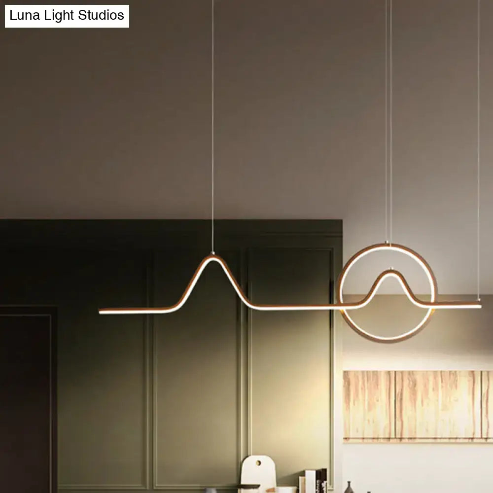 DecorBites sleek island light fixture in black gold metal with minimalistic curves and glowing LED strip lighting