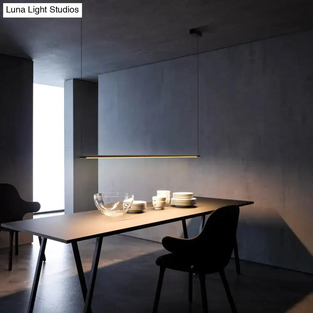 Decorbites sleek metal black led island lamp with minimalist gold linear pendant light above dark dining table