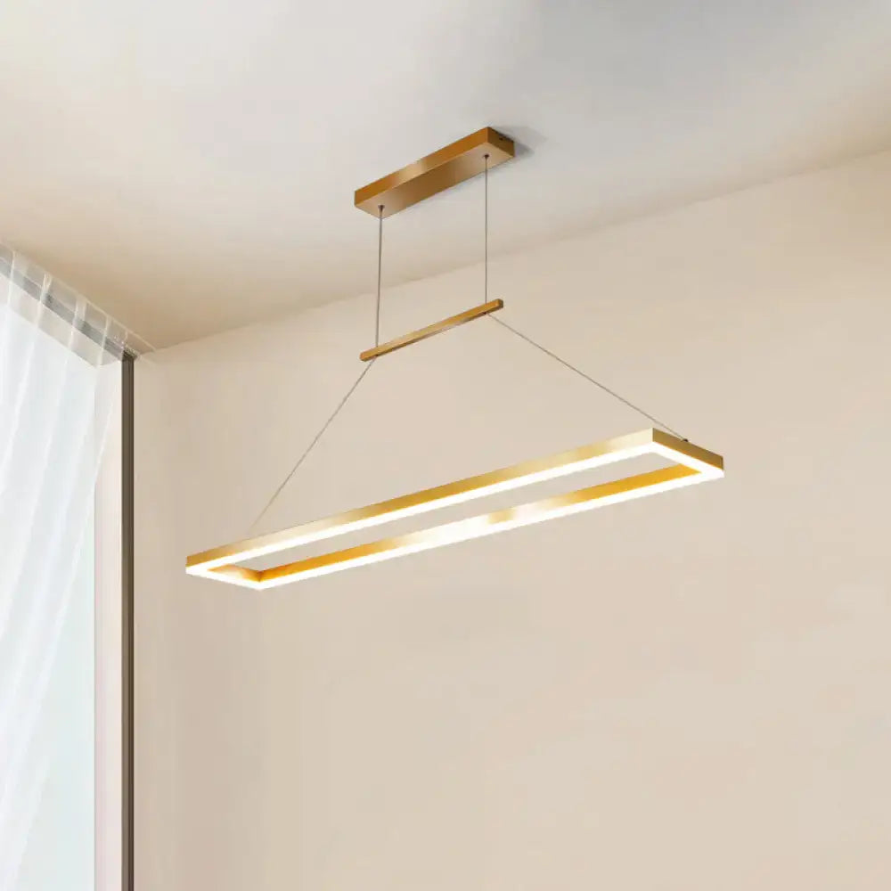 Gold-finished rectangular LED pendant light with sleek metal island ceiling design for modern dining rooms by DecorBites