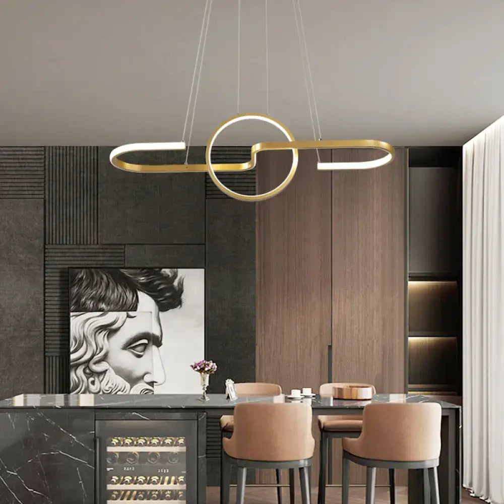 Gold-toned metal decorbites sleek ring and curve dining room pendant light with minimalist interlocking led design