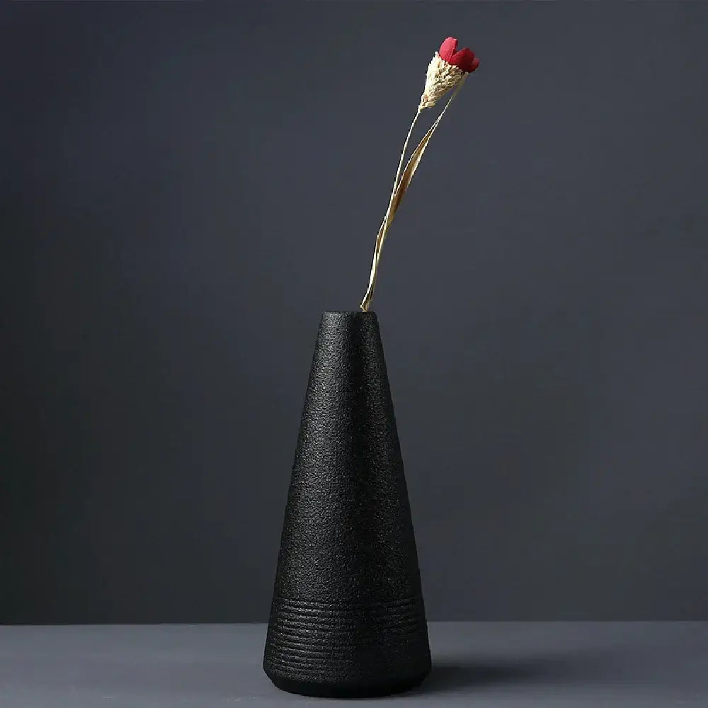 Black textured ceramic small vase with a single dried red flower elegant japanese home decor by DecorBites