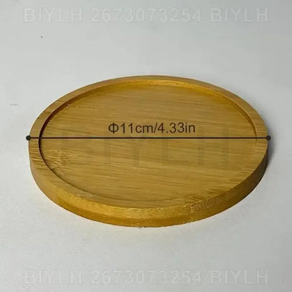 Decorbites™ small transparent glass vase displayed on a round light brown bamboo coaster with natural wood grain pattern