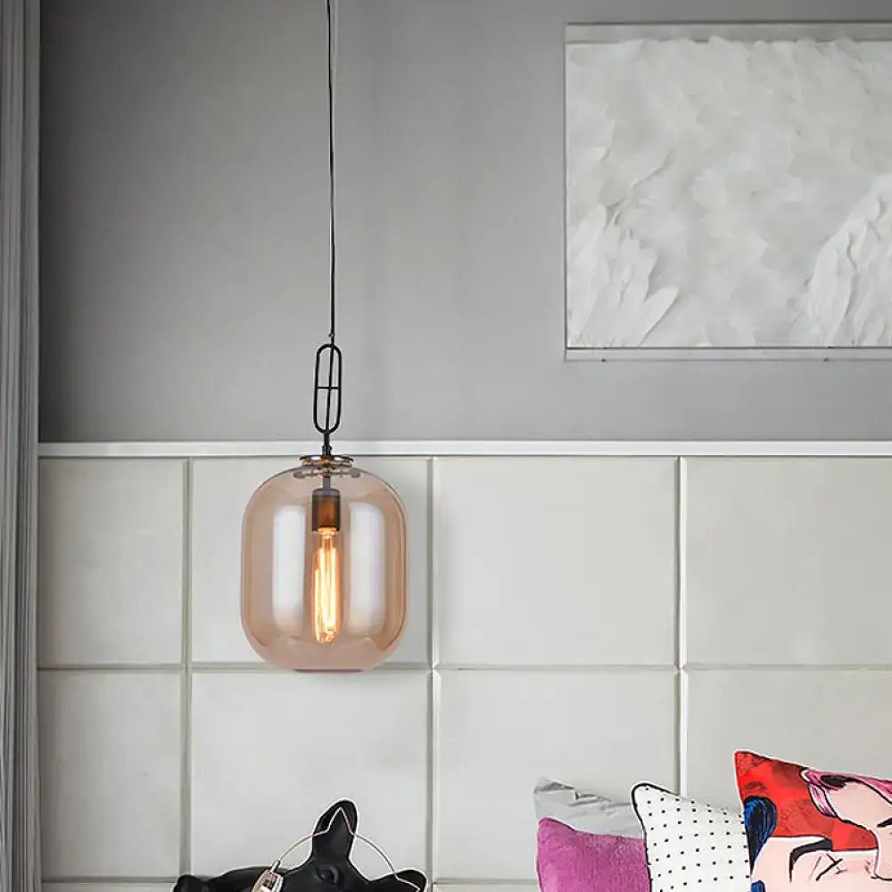 DecorBites™ smoke gray and cognac glass pendant lamp with warm amber tone and black metal chain fixture