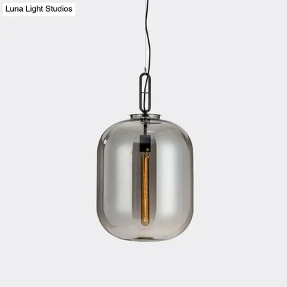 A decorbites smoke gray cognac glass pendant lamp featuring a sleek smoked glass shade with black metal chain