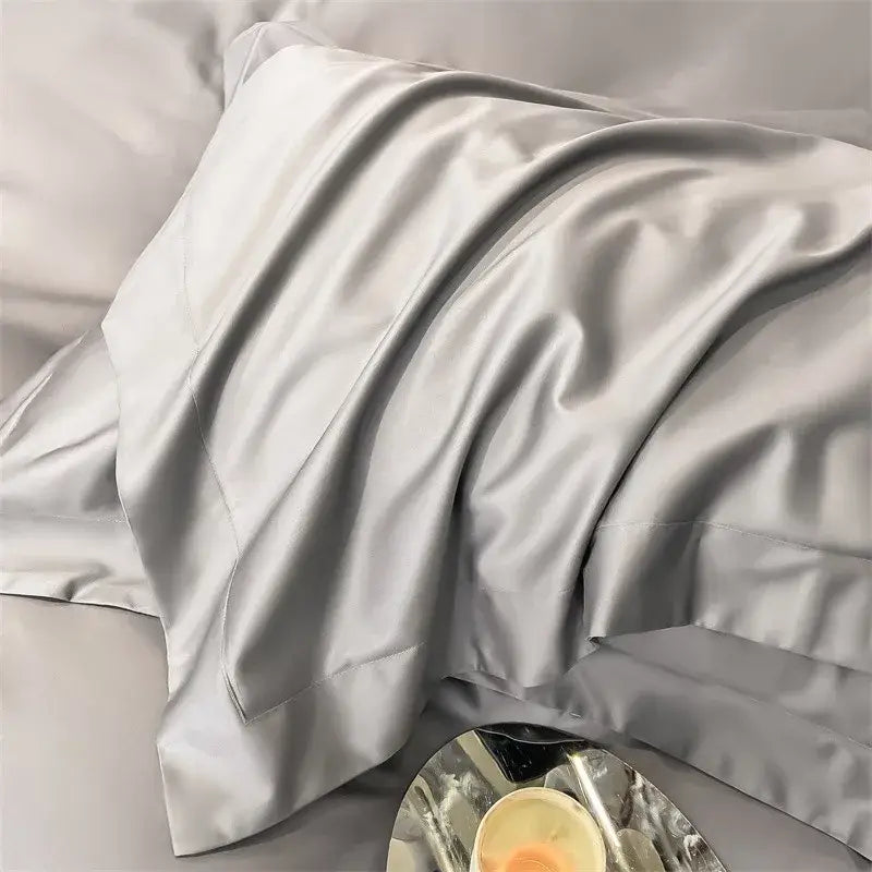 A luxurious silver-gray satin pillowcase with a smooth finish and elegant folds from decorbites 1000tc duvet cover set