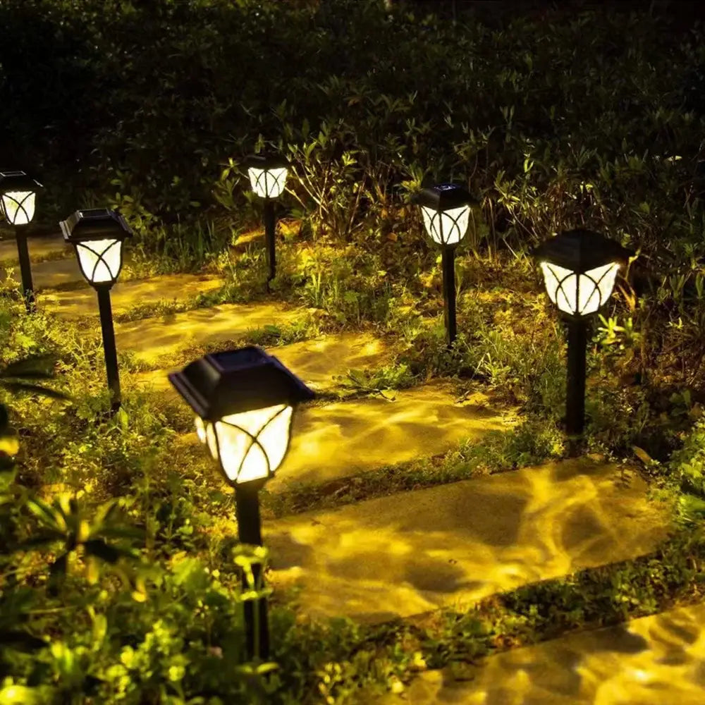 DecorBites™ solar lawn lights set features black lantern-style solar lawn lights with warm yellow illumination for outdoor garden