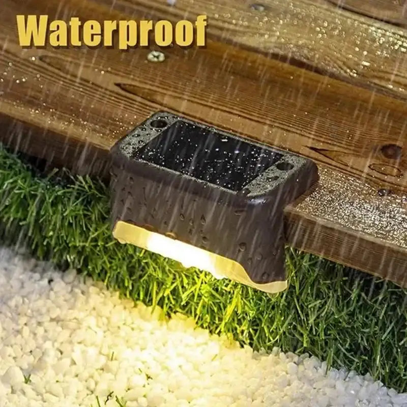 Decorbites™ solar led outdoor step light in black with textured surface and glowing yellow led illumination