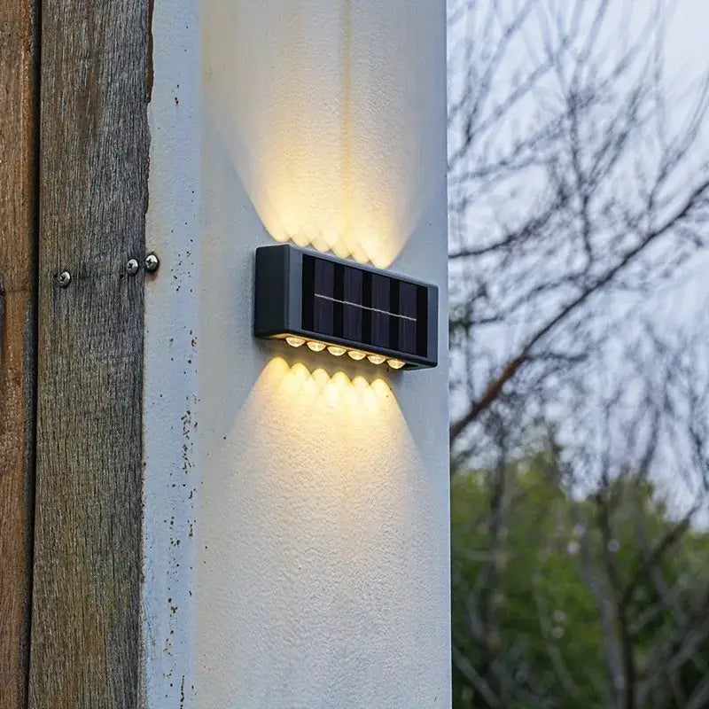 Black rectangular solar led outdoor wall light with multiple warm white led bulbs for garden and patio use