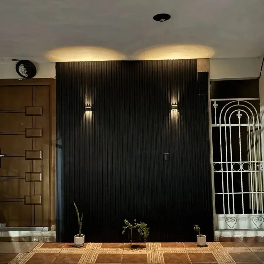 Black vertical panel wall featuring sleek modern design with solar led outdoor wall lights by decorbites for garden use