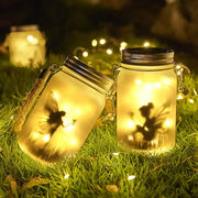 Glass mason jar solar lanterns with fairy silhouettes and warm yellow led lights for garden decoration by decorbites
