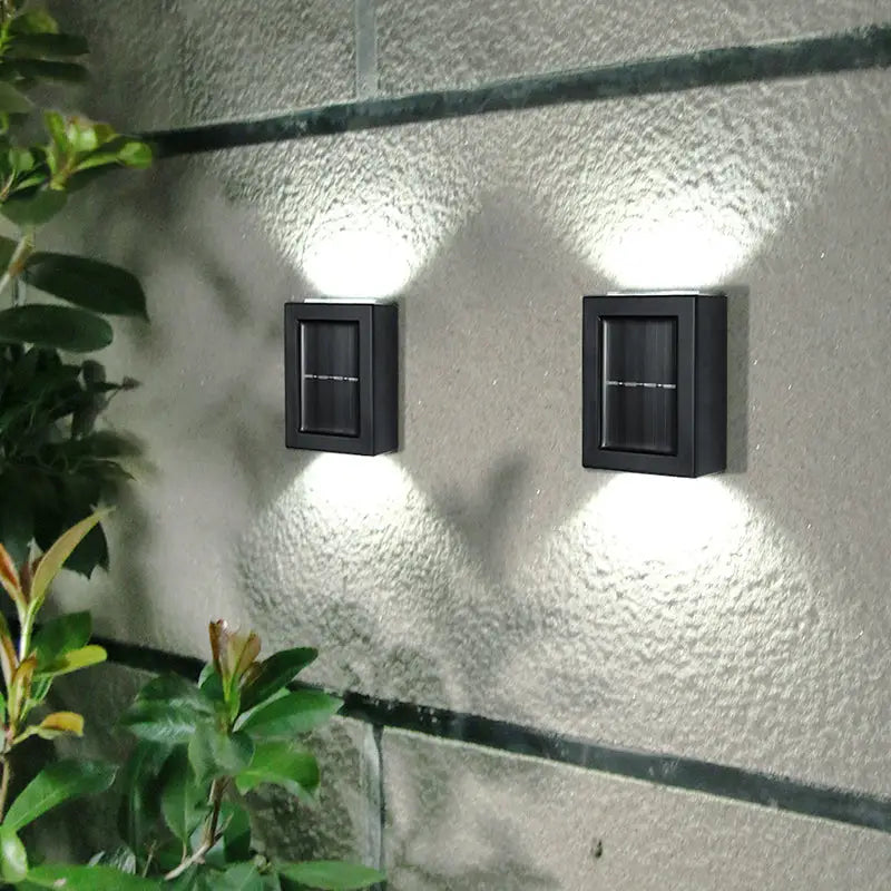 Black rectangular solar-powered decorbites™ wall sconces with integrated led lights for outdoor led garden decoration