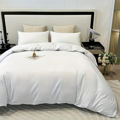 White satin decorbites™ solid color brushed duvet cover set with matching pillowcases neatly arranged on bed